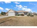 One story house with a screened in garage and small yard at 14315 Se 85Th Ave, Summerfield, FL 34491