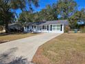 Newly painted house with a spacious yard and long driveway at 3333 Se 12Th St, Ocala, FL 34471