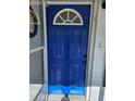 Charming blue front door with a half-round window at 3333 Se 12Th St, Ocala, FL 34471