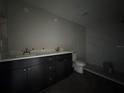 Modern bathroom with dark vanity and a walk-in shower at 3941 Se 137Th Ln, Summerfield, FL 34491