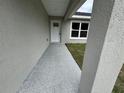 View of the house's textured walkway to the front door at 3941 Se 137Th Ln, Summerfield, FL 34491