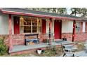 Charming front porch with brick columns, string lights, and rustic decor at 5625 Sw 181St Ct, Dunnellon, FL 34432