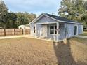 Newly built home, featuring a covered porch and a fenced backyard at 5739 Se 163Rd Ct, Ocklawaha, FL 32179