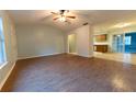 Bright living room features wood-look floors and a ceiling fan at 6006 Nw 62Nd Pl, Ocala, FL 34482