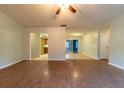 Open living room with kitchen access and wood-look floors at 6006 Nw 62Nd Pl, Ocala, FL 34482