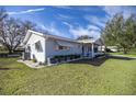 Light blue ranch home with well-manicured lawn at 6460 Sw 111Th St, Ocala, FL 34476