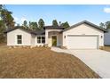 New construction, single-story home with a two-car garage and a yard at 7747 Sw 146Th Lane Rd, Ocala, FL 34473