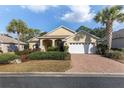 Inviting single-Gathering home with a brick driveway, two-car garage, and well manicured landscaping at 8535 Sw 82Nd Ter, Ocala, FL 34481