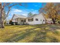 White house with a gray roof and a spacious lawn at 8890 Sw 96Th St # D, Ocala, FL 34481