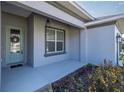 Front porch with a light fixture and decorative plants at 891 Nw 44Th Street Rd, Ocala, FL 34475