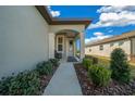 Front entry with walkway, landscaping, and a bench at 8958 Sw 57Th Place Rd, Ocala, FL 34481