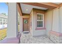 Front porch with brown door, wreath, and stone accents at 9119 Sw 70Th Loop, Ocala, FL 34481