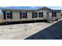 Tan mobile home with black shutters and a grey front porch at 9160 Sw 31St Avenue Rd, Ocala, FL 34476