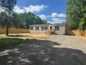 Lovely home featuring a front yard, driveway, and mature trees providing shade at 9160 Sw 31St Avenue Rd, Ocala, FL 34476