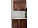 Well-maintained dark wood kitchen cabinets with counter space and plenty of storage at 9160 Sw 31St Avenue Rd, Ocala, FL 34476
