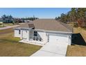 Newly constructed home with a gray roof and white exterior at 9780 Sw 42Nd Ave, Ocala, FL 34476