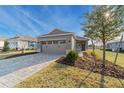 Two-car garage and a paved driveway at 10277 Sw 96Th Loop, Ocala, FL 34481