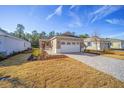 Beautiful home exterior with a stone driveway, manicured lawn, and an inviting entrance, perfect for a growing Gathering at 10306 Sw 99Th Ln, Ocala, FL 34481