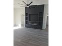 Living room featuring a black accent wall with a built-in fireplace and shelving at 12217 Sw 67Th Ln, Ocala, FL 34481