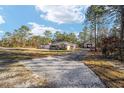 House with a gravel driveway and detached shop at 13700 Sw 71St Ln, Ocala, FL 34481