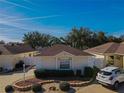 Tan one-story house with brown roof and landscaped yard at 17074 Se 75Th Wickson Ct, The Villages, FL 32162