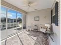 Cozy screened porch with seating area, perfect for relaxing at 1817 Hallandale Ln, The Villages, FL 32162