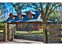 Stone pillars and wrought iron gate with horse emblem at 1838 Sw 97Th Pl, Ocala, FL 34476