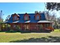 Spacious log home exterior with green roof and landscaping at 1838 Sw 97Th Pl, Ocala, FL 34476