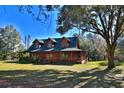 Log home with mature trees and expansive lawn at 1838 Sw 97Th Pl, Ocala, FL 34476