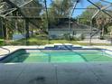 Refreshing pool in a screened enclosure, offering a private outdoor oasis with verdant backyard views at 1908 Sw 28Th St, Ocala, FL 34471