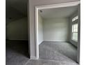 Bright bedroom featuring plush carpet and large window with ample natural light at 35 Locust Radial Cir, Ocala, FL 34472