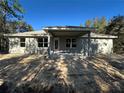 Newly constructed home with covered patio, showcasing a modern design at 35 Locust Radial Cir, Ocala, FL 34472