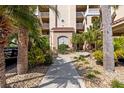 Condo building entry with lush landscaping and fountain at 438 Bouchelle Dr # 401, New Smyrna Beach, FL 32169