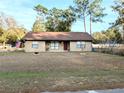 One-story house with brown roof, red door, and American flag at 5991 Nw 61St Ct, Ocala, FL 34482