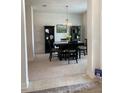 Formal dining room with dark wood table, chairs, and decorative accents at 613 Marion Oaks Trl, Ocala, FL 34473