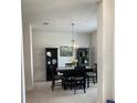 Formal dining room with dark wood table, chairs, and decorative accents at 613 Marion Oaks Trl, Ocala, FL 34473