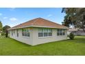 Side view of the house showing multiple windows and a grassy yard at 6558 Se 9Th Pl, Ocala, FL 34472