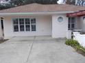 Exterior view of a single-story house with a light pink facade and a brown roof at 7106 Sw 115Th Loop, Ocala, FL 34476