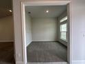 A versatile home office space bathed in natural light with neutral walls and carpet at 77 Olive Dr, Ocala, FL 34472