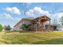 Backyard with deck, pergola, and lush landscaping at 7727 Sw 102Nd Loop, Ocala, FL 34476