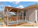 Covered patio with wooden pergola, deck, and outdoor seating at 7727 Sw 102Nd Loop, Ocala, FL 34476