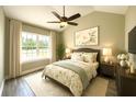 Bright bedroom features a ceiling fan, large window, neutral walls and coordinated bedding at 7799 Sw 132Nd Pl # 10, Ocala, FL 34473