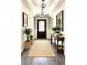 Inviting entryway featuring hardwood floors, stylish lighting, and elegant decor at 7799 Sw 132Nd Pl # 10, Ocala, FL 34473