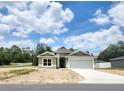 Charming single-story home with a two-car garage, neutral paint, and a well-manicured lawn at 7799 Sw 132Nd Pl # 10, Ocala, FL 34473