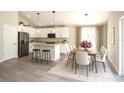 Bright kitchen with white cabinets, stainless steel appliances, and adjacent dining area at 7799 Sw 132Nd Pl # 10, Ocala, FL 34473