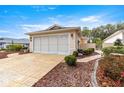 Front view of a single-story house with a large garage and attractive landscaping at 9176 Sw 93Rd Cir, Ocala, FL 34481