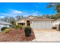 One-story house with a two-car garage and well-maintained landscaping at 9176 Sw 93Rd Cir, Ocala, FL 34481