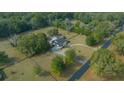 Expansive aerial view of property with large lot, mature trees, and screened in pool at 9748 Sw 74Th Ave, Ocala, FL 34476