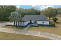 Charming single-story home with a striking red front door and mature palm tree at 9748 Sw 74Th Ave, Ocala, FL 34476