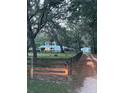 Gated property with a two story home, mature trees and an oversized driveway at 10245 Sw 105Th St, Ocala, FL 34481